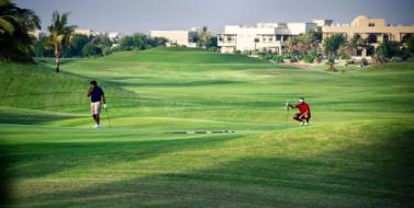 Golf players at the Montgomerie Golf Club which surrounds Emirates Hills